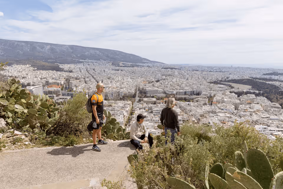 Small group enjoying views from an Athens hilltop during a walking tour