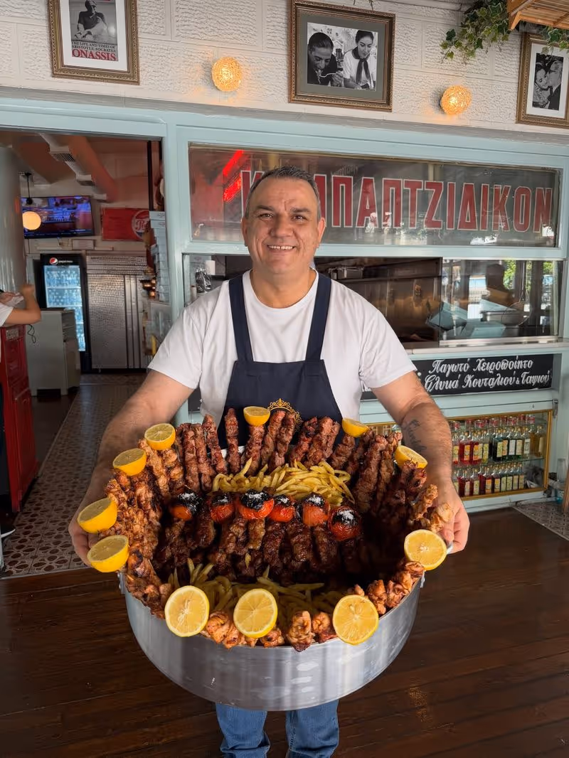 Kyr Aristos restaurant in Palaio Faliro — an enormous tray of grilled meats being served