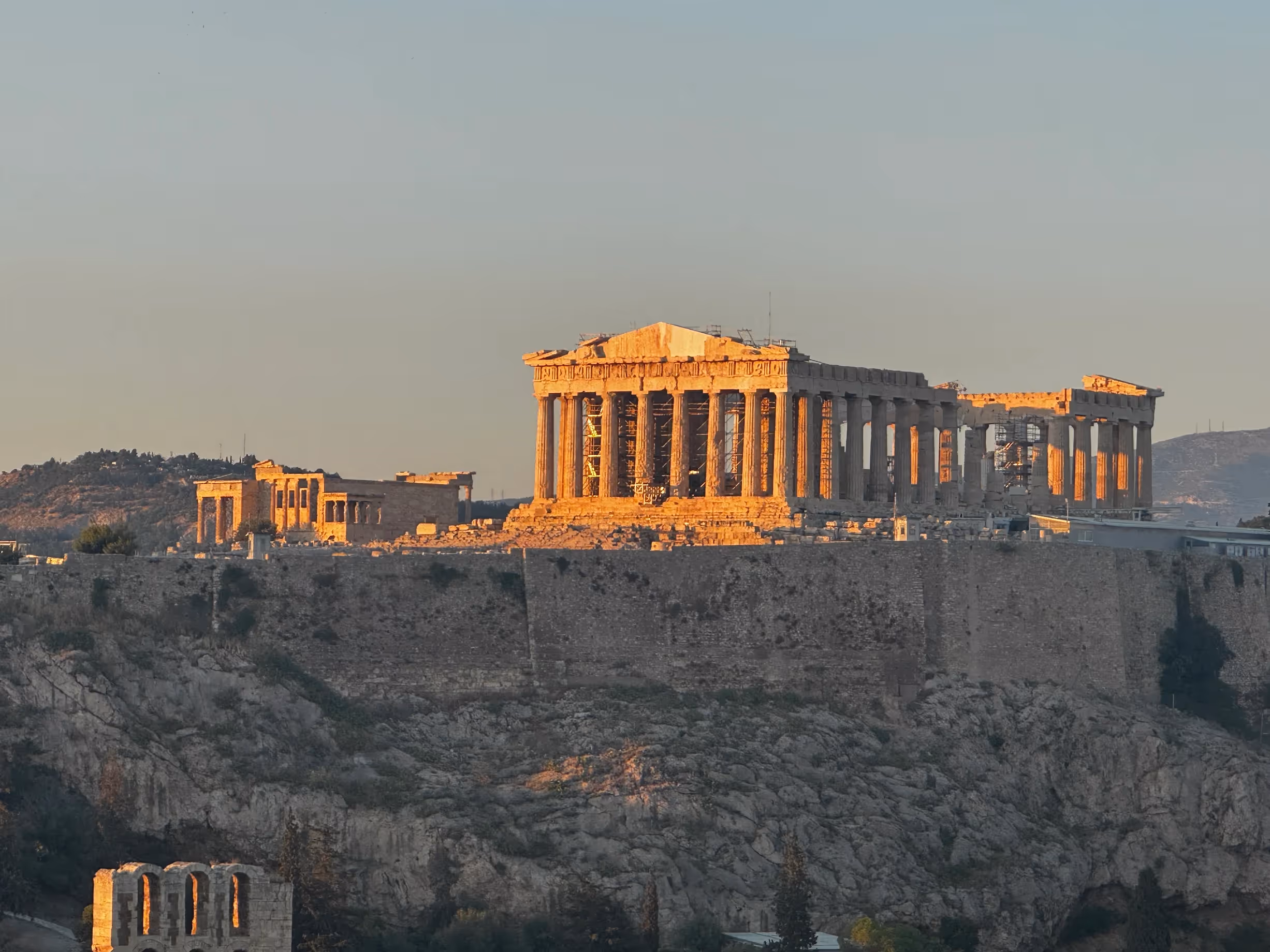 The Parthenon lit gold by early morning light, seen from Areopagus Hill in Athens